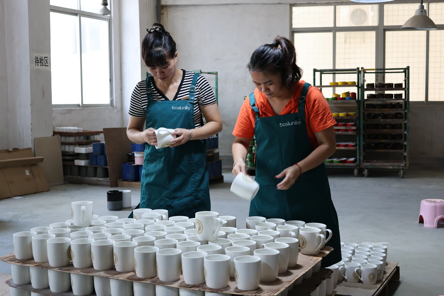 Original YST workers inspecting ceramic mugs before shipment